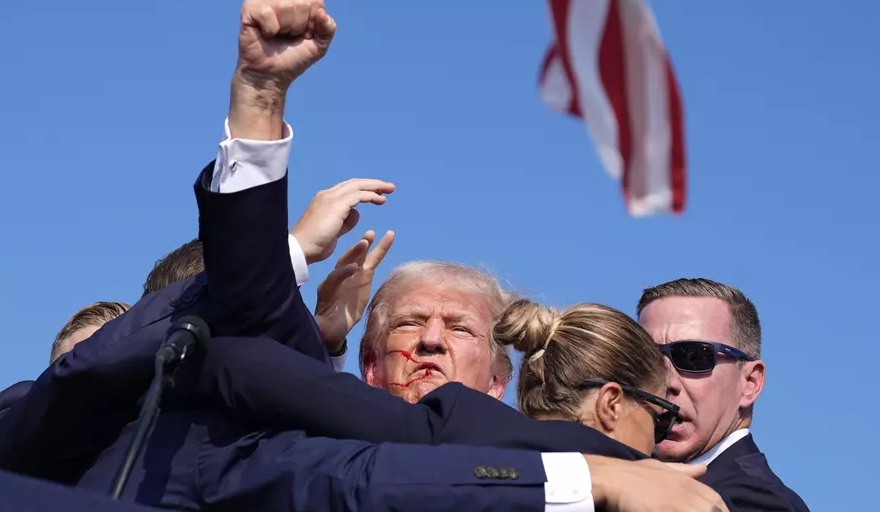 Republican presidential candidate former President Donald Trump is surrounded by U.S. Secret Service agents at a campaign rally, Saturday, July 13, 2024, in Butler, Pa. (AP Photo/Evan Vucci)